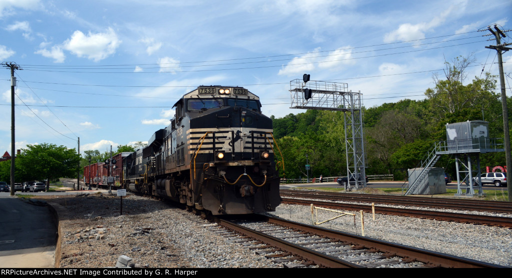 NS yard job E19 starts back up the hill with four cars received from CSX.  CSX signal and bungalows for the switch for the "switching lead" to Main 1 to the right.